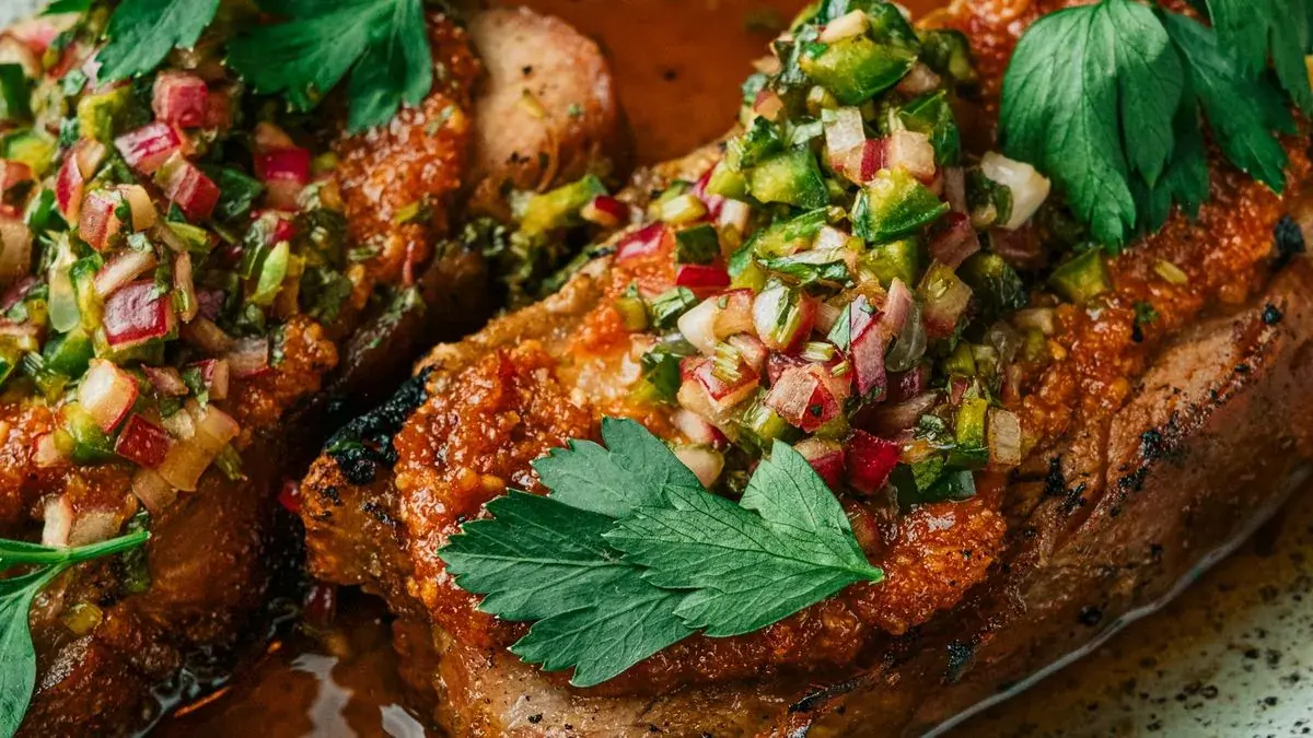 Seared pork chops topped with a fresh herb relish