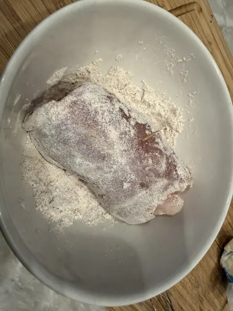 A chicken bundle rolled in the seasoned flour