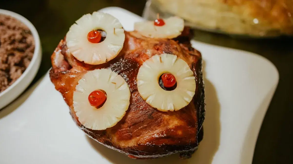 Glazed pork topped with pineapple rings and cherries
