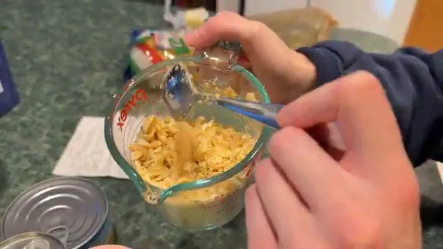 Crushing Ritz crackers into melted butter for the topping