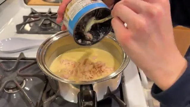 Adding the chicken to the creamy cheese sauce