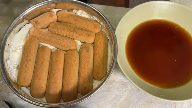 Ladyfingers dipped in espresso and layered in the pan