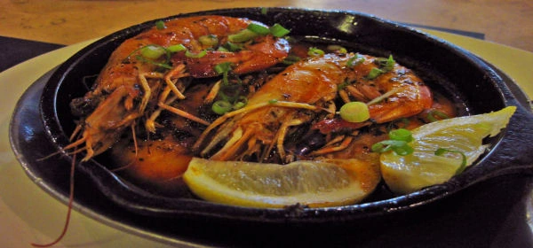 Shrimp in a cast-iron skillet with lemon
