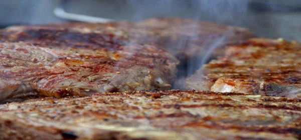 Steaks searing on a grill