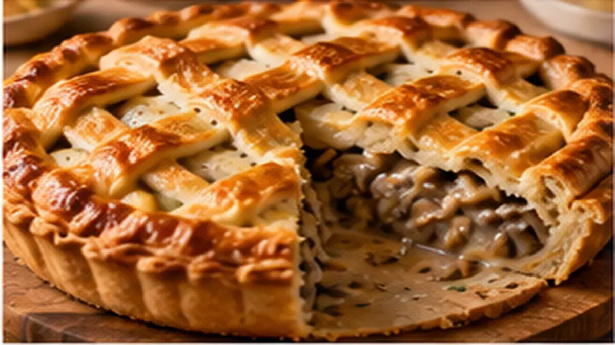 Lattice-topped mushroom pie with a slice cut out showing the mushroom filling