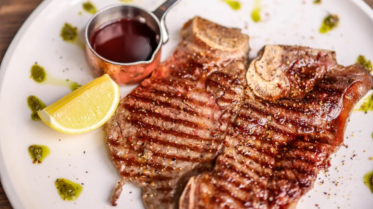Grilled T-bone steak with lemon and sauce