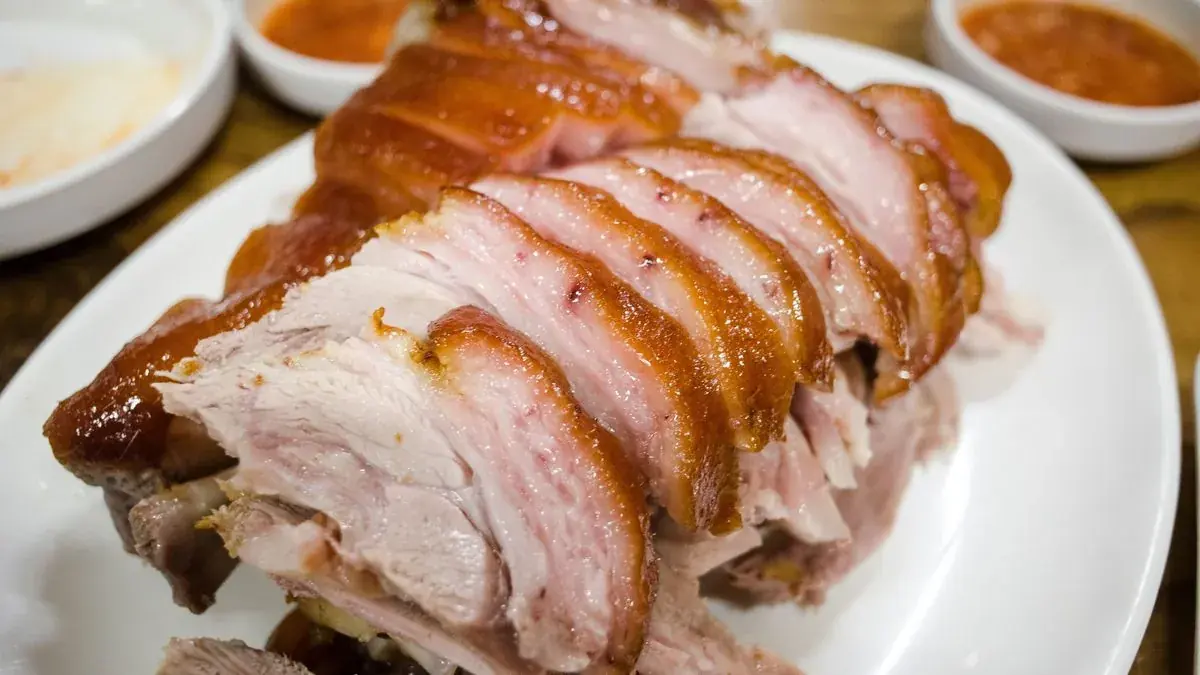 Sliced roast pork with crisp, glazed skin