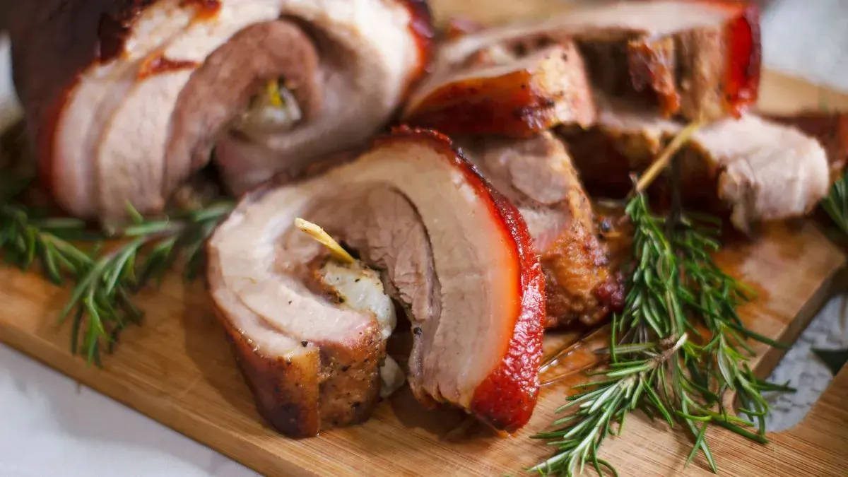 Sliced rolled stuffed pork roast with rosemary
